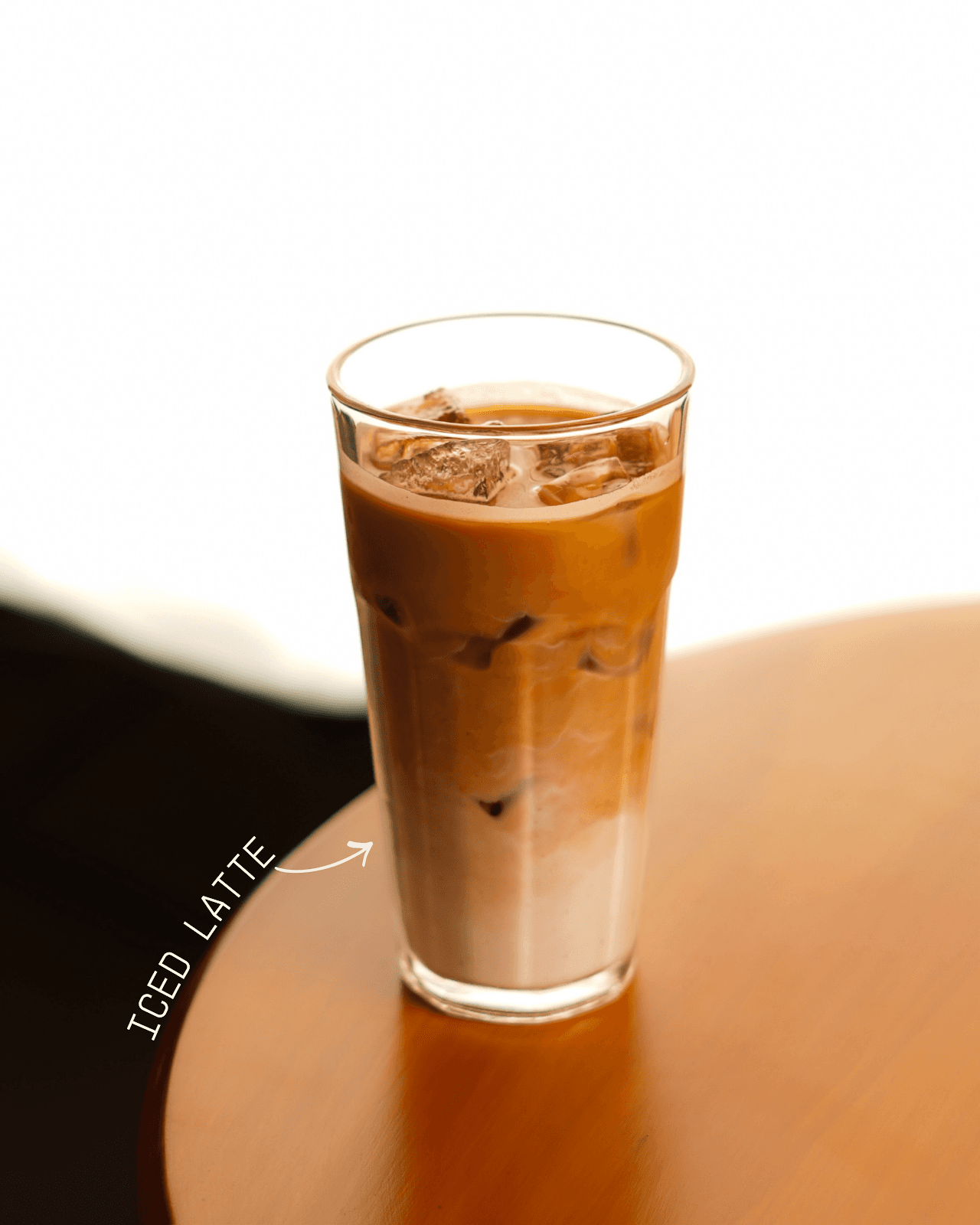 Iced latte at 93 Brew — cold milk and double espresso over ice in a tall glass